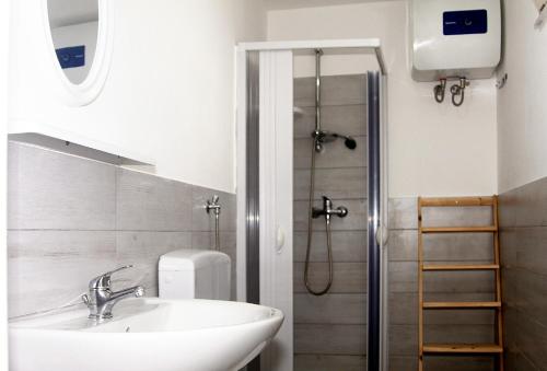 a bathroom with a sink and a shower at Camping Serenella in Rodi Garganico