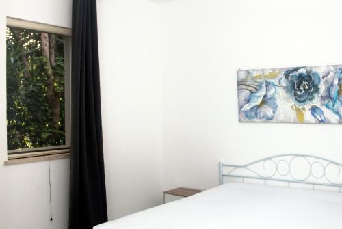 a bedroom with a bed and a window at Camping Serenella in Rodi Garganico