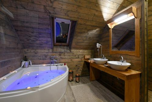 a bathroom with two sinks and a large tub at Lakeside Hotel Plitvice in Plitvička Jezera