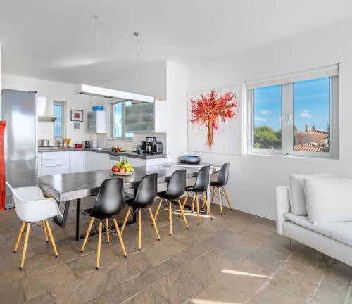 a kitchen and dining room with a table and chairs at Villa Thalia Floating Heaven in Porto Heli