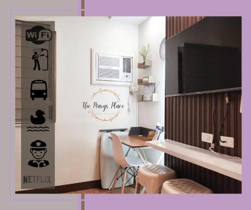 a kitchen with a table and some stools in a room at The Marys Place-Cozy&Modern Fully Furnished StudioType Condo at MesaVerte Residences in Cagayan de Oro
