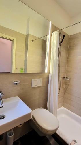 a bathroom with a toilet and a sink and a shower at Hotel Pestalozzi Lugano in Lugano
