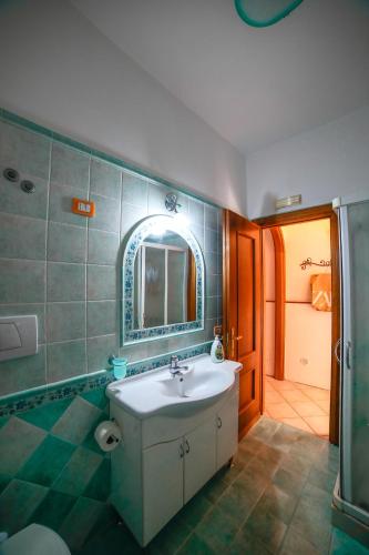 a bathroom with a sink and a mirror and a shower at Sole Holiday House Pontone Holiday house in Pontone