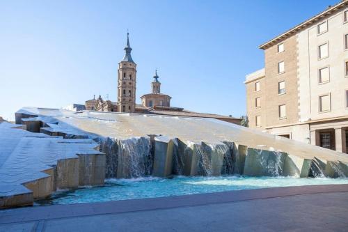 a water fall in the middle of a city at Moderno apartamento en casco histórico + desayuno! in Zaragoza