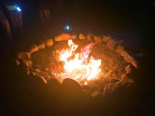 a fire in a fire pit at night at Rare River Views & Access, Cabin by Eden Islands in Montague