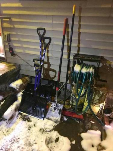 a group of skis and ski poles in front of a garage at Rare River Views & Access, Cabin by Eden Islands in Montague