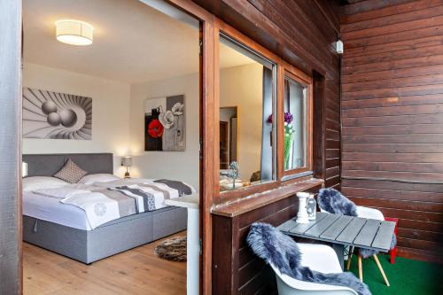 a bedroom with a bed and a table and chairs at Haus Excelsior Top 36 in Seefeld in Tirol