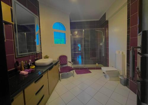 a bathroom with a sink and a toilet and a shower at Royal Mariout Villa in King Mariout