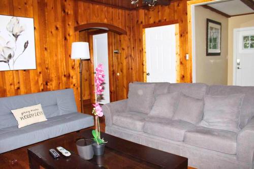 a living room with a couch and a table at Rare River Views & Access, Cabin by Eden Islands in Montague