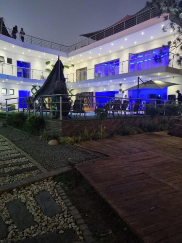 a building with blue lights on it at night at Botle Ba Afrika Lodge in Vereeniging
