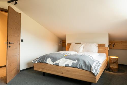 a bedroom with a bed with a wooden headboard at Alte Bildhauerei in Aurach bei Kitzbuhel