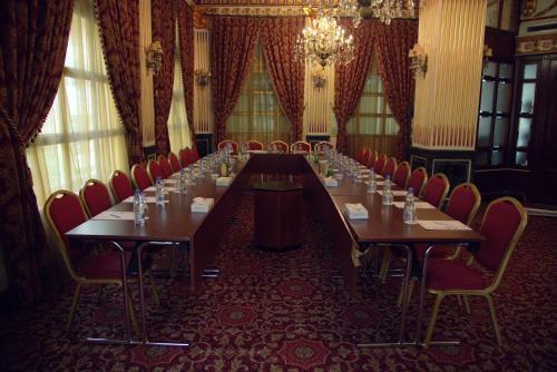 a long table in a room with red chairs at Serenada Golden Palace - Boutique Hotel in Beirut