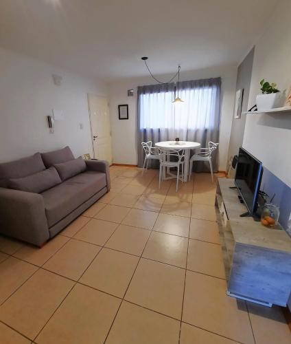a living room with a couch and a table at Departamentos René in Ciudad Lujan de Cuyo