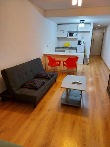 salon z kanapą i 2 czerwonymi krzesłami w obiekcie UNICO STUDIO w BuenosAires