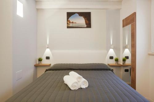 a bedroom with a bed with two towels on it at Affittacamere Somnium in Sirolo