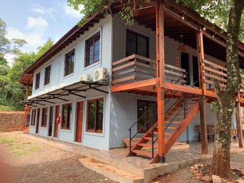 a house with a staircase on the side of it at Orquídeas De La Selva in Puerto Iguazú