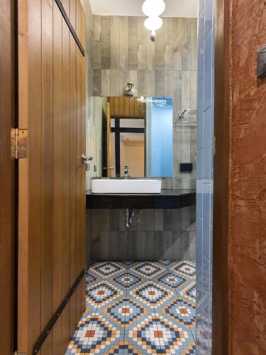 a bathroom with a sink and a mirror at Oxy Resort in Ban Mai Phatthana