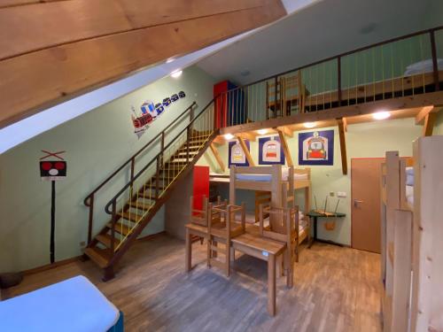 a room with a spiral staircase in a building at Středisko ekologické výchovy SEVER in Horní Maršov