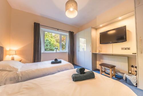 Ένα ή περισσότερα κρεβάτια σε δωμάτιο στο Top Garden Suite Far Sawrey Windermere