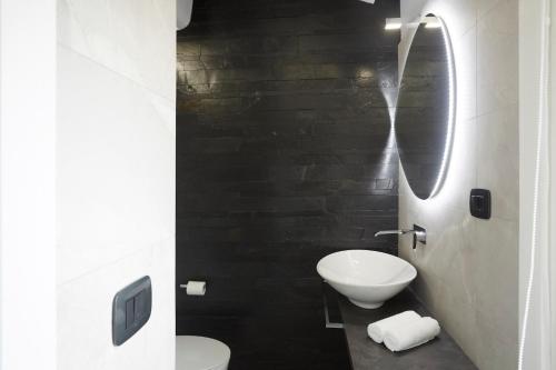 a bathroom with a white toilet and a sink at Affittacamere Somnium in Sirolo