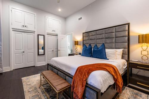 a bedroom with a large bed with blue pillows at The Crescent in New Orleans