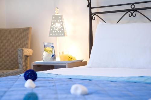 a bedroom with a bed and a lamp at Anemolia Apartments in Vasiliki