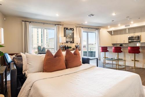 a bedroom with a large white bed with orange pillows at The Bonaparte in New Orleans