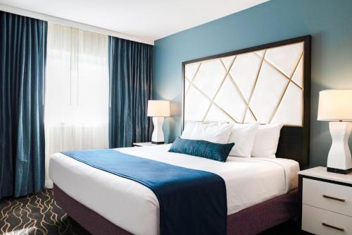 a bedroom with a large bed with a blue wall at WorldMark Anaheim in Anaheim