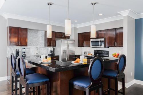 a kitchen with a large island with blue bar stools at WorldMark Anaheim in Anaheim