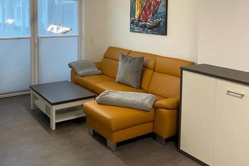 a living room with a couch and a coffee table at Ferienhof Elbaue in Schönebeck