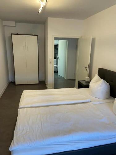 a large white bed in a room with a roomswersswersswersswersswersswers at Ferienhof Elbaue in Schönebeck