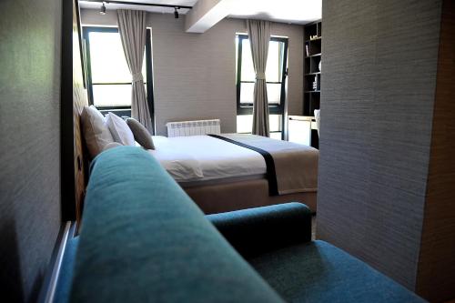 a hotel room with a bed and a couch at Modern Mountain in Kolašin