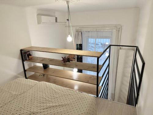 a room with a staircase with a bed and a table at Twenty2 Apartment in Budapest
