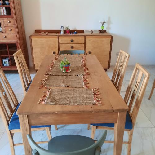 a wooden table with four chairs and a table with at Inocencia Faez in Roldán