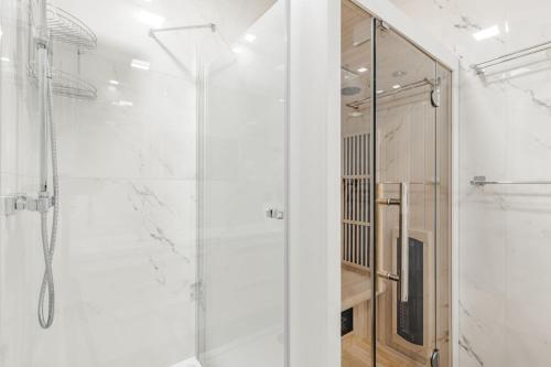 a bathroom with a shower with a glass door at Sun&Sport Apartament MAJA z ogródkiem in Szczyrk