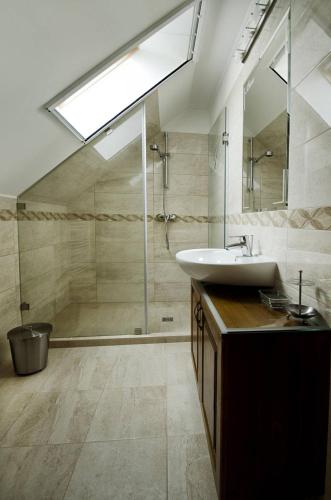 a bathroom with a sink and a shower at Bocor Fogadó in Kisharsány