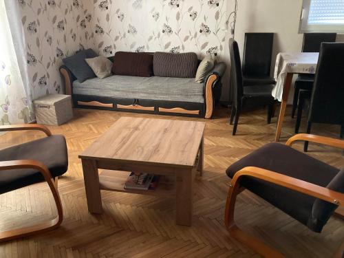 a living room with a couch and a coffee table at AN-TA Nyaraló Harkány in Harkány