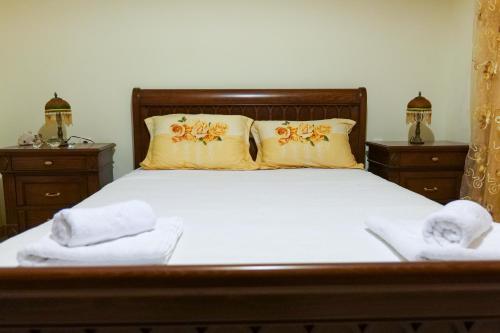 a bedroom with a bed with two towels on it at Sunny Holiday in Sarandë