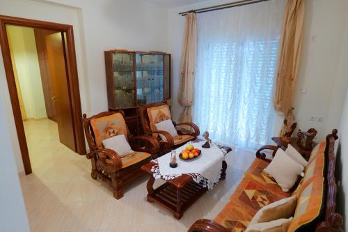 a living room with a table and chairs and a couch at Sunny Holiday in Sarandë