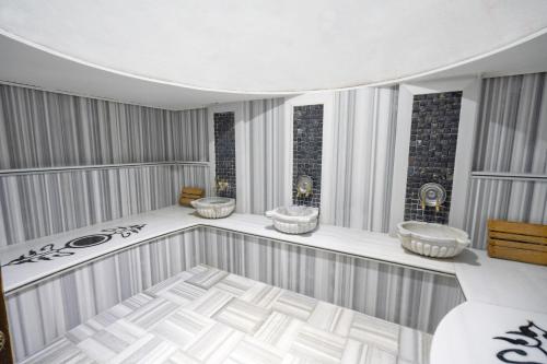 a bathroom with three sinks in a room at The Green Park Taksim in Istanbul