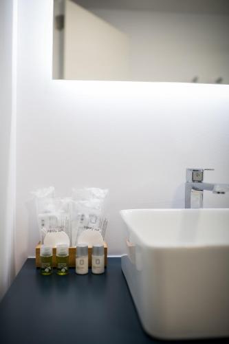a white bathroom with a sink and a white toilet at MAR BIANCO - Gay Men Only in Maspalomas