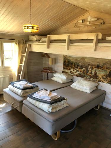 a bedroom with two bunk beds in a attic at Tofvehults Boende in Skaftet