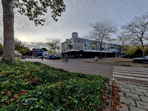 a building on a street with a person riding a bike at Eindhoven City Apartments G 4P Free public parking in Eindhoven