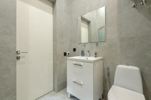 a bathroom with a toilet and a sink and a mirror at Smart App near Railway Station Kvartet 3C in Kyiv