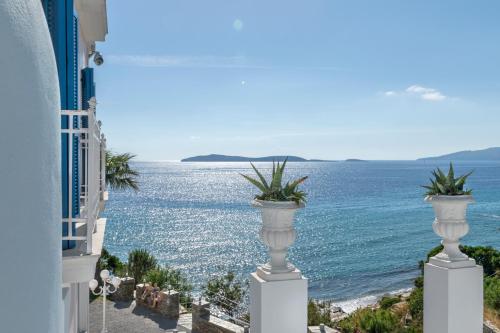 a view of the ocean from between two buildings at Aneroussa Beach Hotel in Batsi