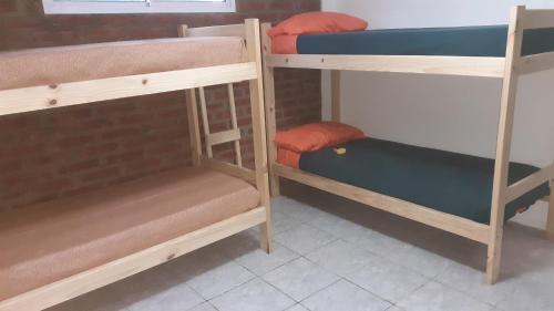 a group of bunk beds in a room at Cabaña pared de piedra in Carpintería