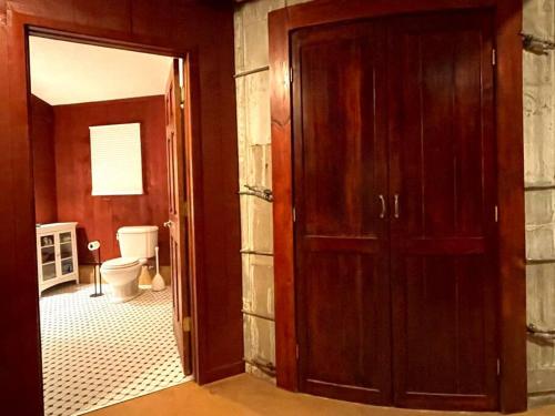 an open door to a bathroom with a toilet at Beautifully restored five bedroom historic barn in Oakwood