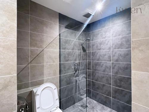 a bathroom with a shower stall with a toilet at KWEN Suites-Tanjung Aru InfinityPool Seaview/Airport View in Kota Kinabalu