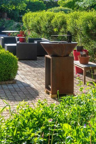 a fountain in the middle of a garden with plants at Le Clos d'Albray - Chambres d'hôtes et gite in Comps-la-Grand-Ville