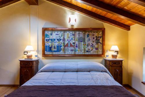 a bedroom with a large bed with two night stands at Affittacamere Is Coronas in Ìsili